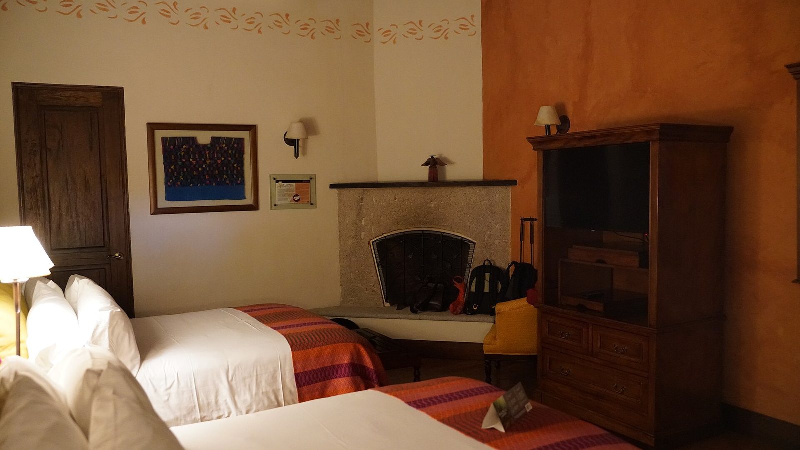 A neatly made bed with white linen in a bright bedroom